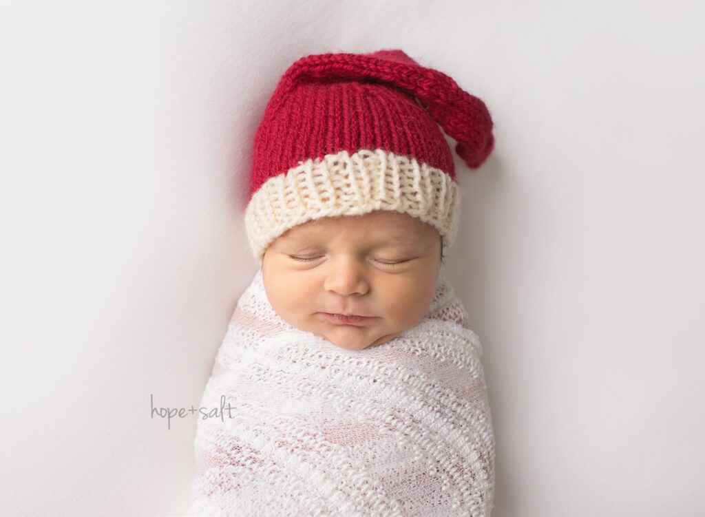 burlington studio newborn photographer - simple natural organic minimalist style for Christmas baby with Santa hat holiday card